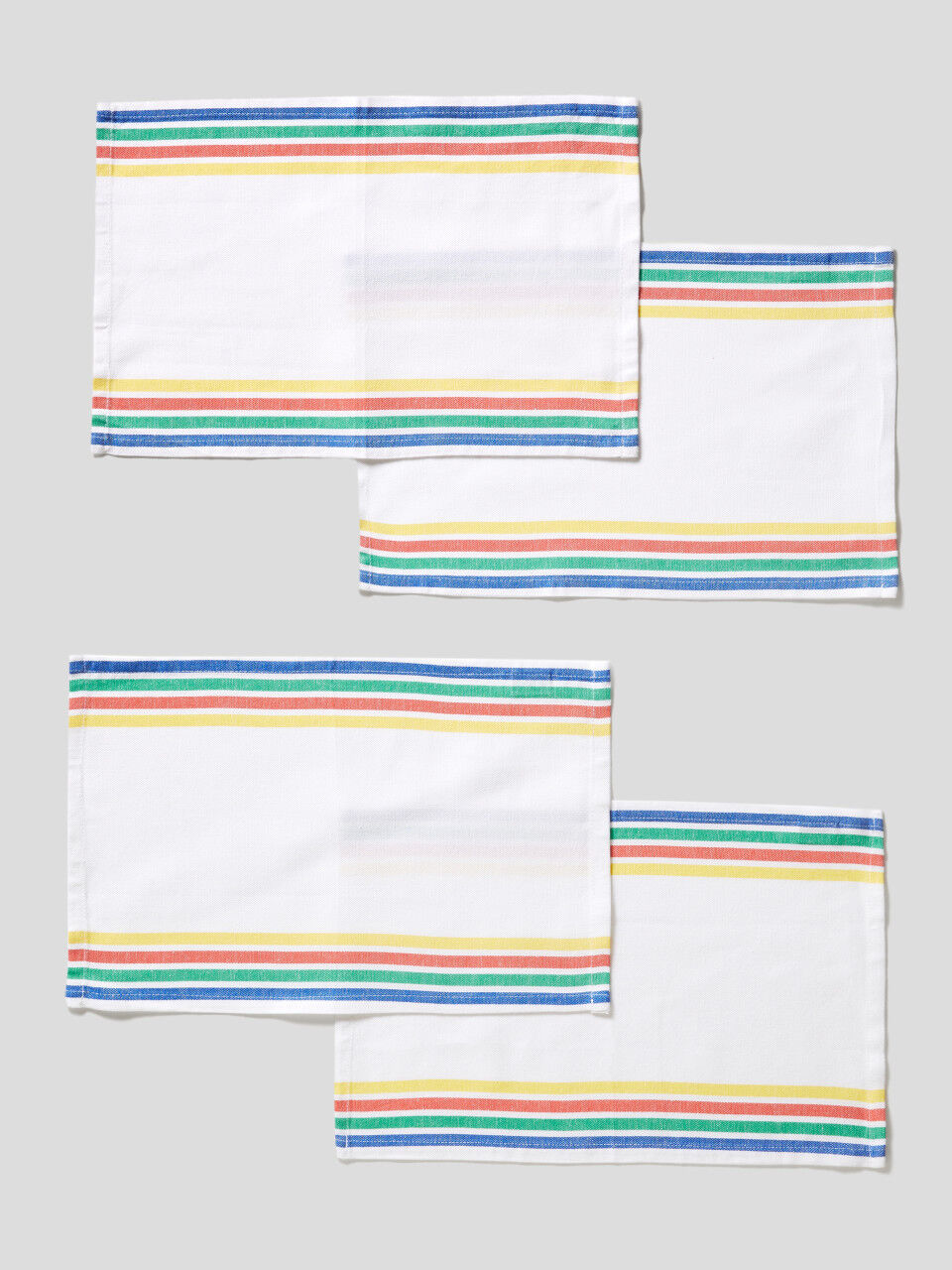 Four placemats with multicolor stripes